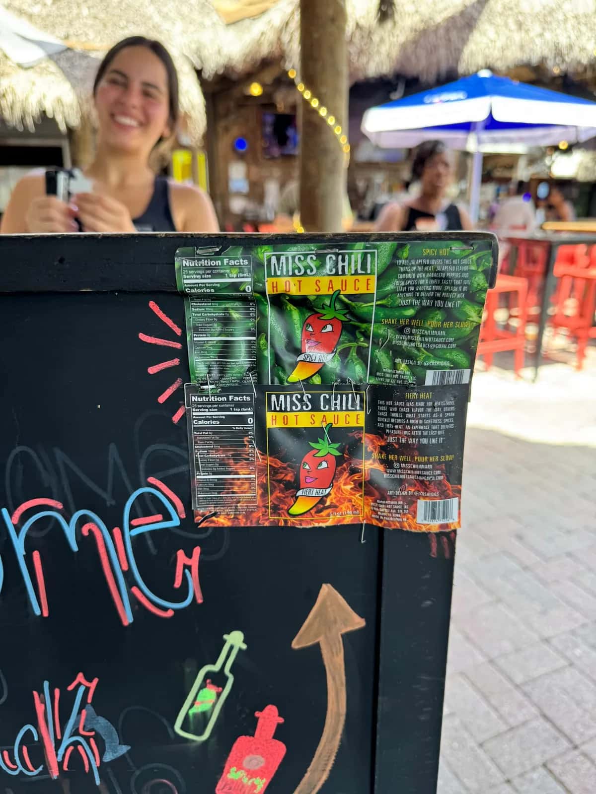 Miss Chili stickers on a wall at an outdoor bar in Miami
