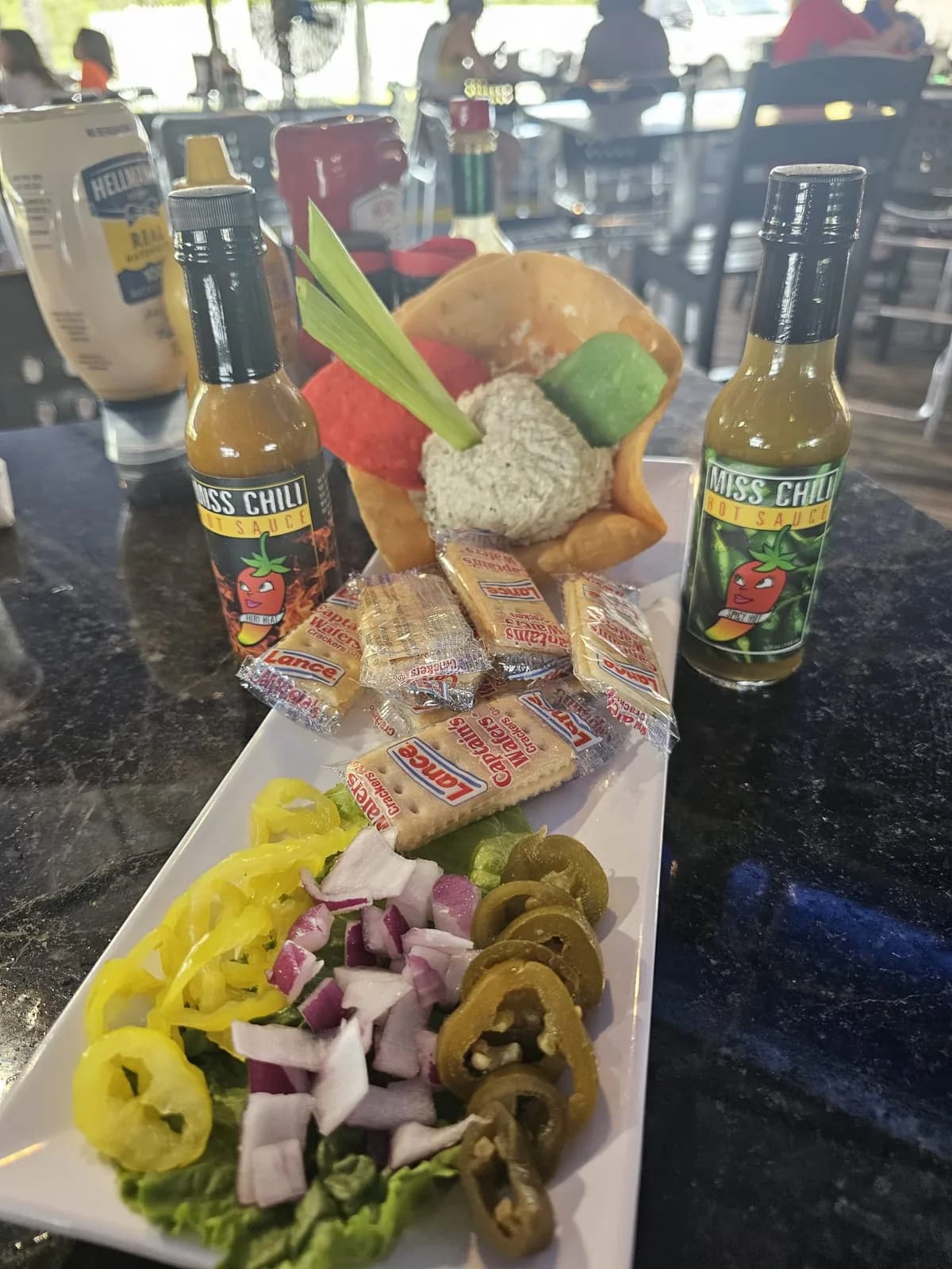 Bar snacks served with Miss Chili hot sauce