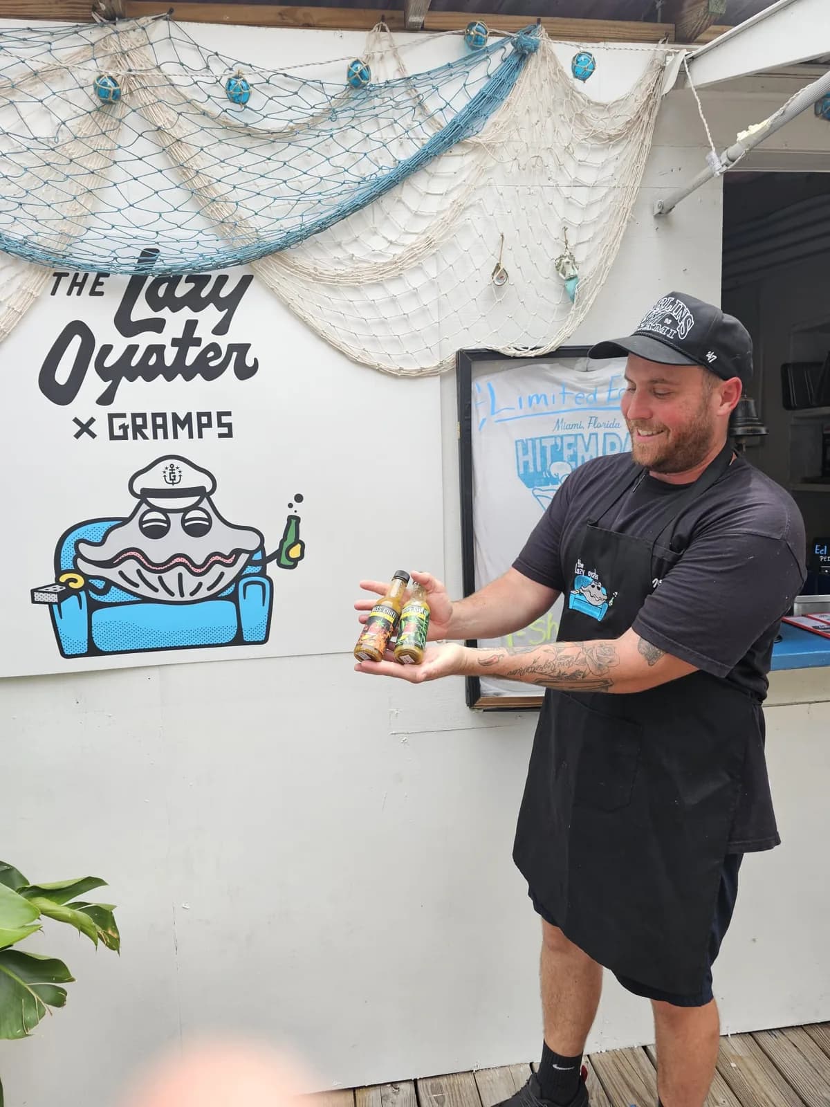 A restaurant partner showcasing Miss Chili hot sauce